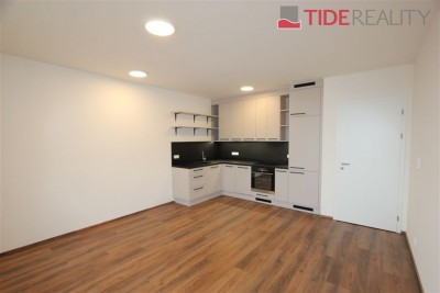 Modern 2+kk apartment with a balcony and a parking space in a newly completed building.